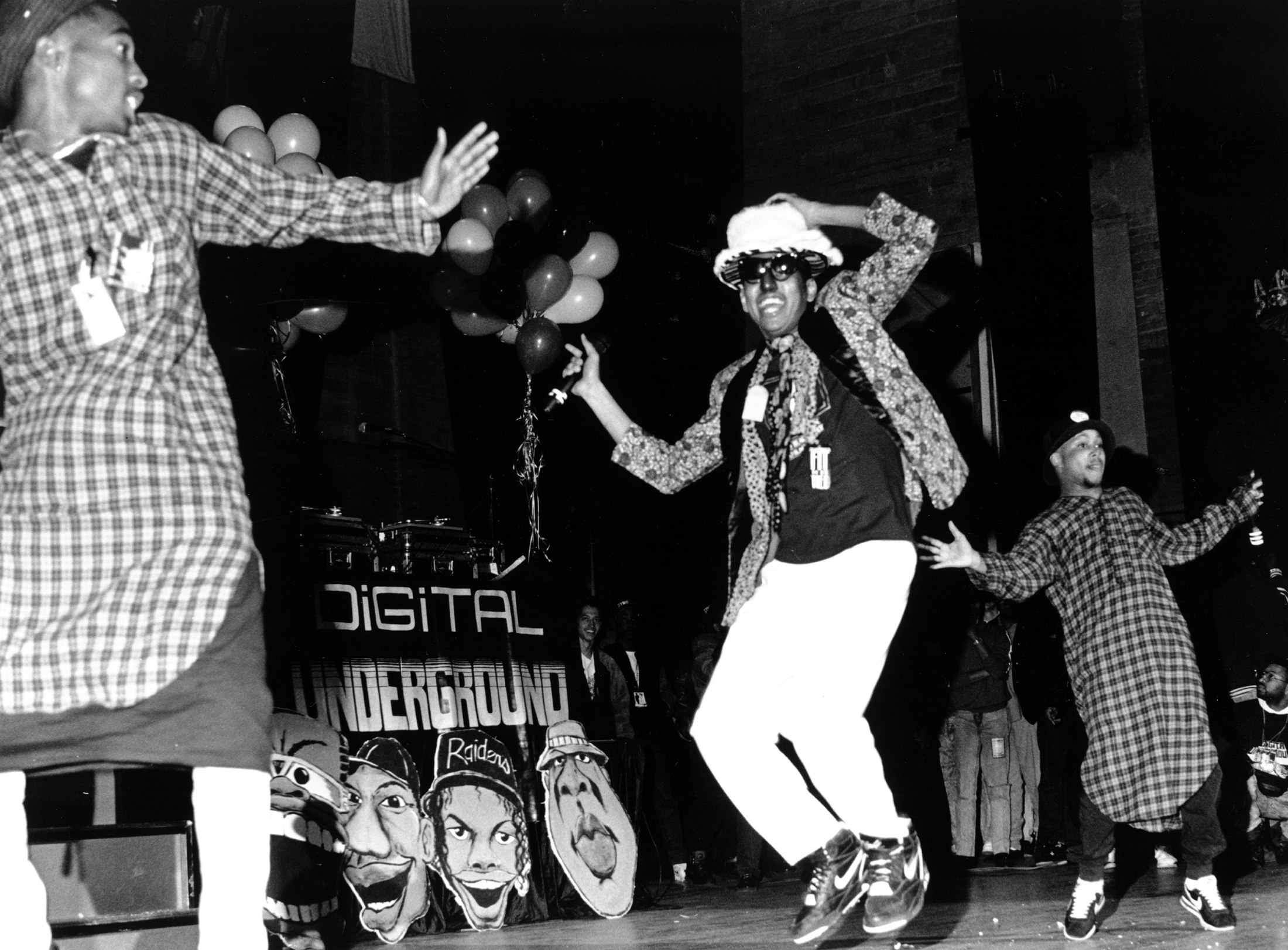 Tupac (far left) onstage with Shock G and Digital Underground. Photo by Al Pereira/Michael Ochs Archives/Getty Images.
